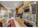 Gourmet kitchen with stainless appliances, custom cabinetry, and tiled backsplash at 2660 Peachtree Nw Rd # 10H, Atlanta, GA 30305
