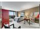 The main bedroom features a sitting area, balcony access with a view and neutral colors for a relaxing space at 2660 Peachtree Nw Rd # 10H, Atlanta, GA 30305