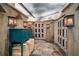 Elegant wine cellar featuring custom cabinets, unique lighting, and stone flooring, designed for wine enthusiasts at 2660 Peachtree Nw Rd # 10H, Atlanta, GA 30305