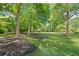 Lush backyard with mature trees and impeccable landscaping offers a serene and private outdoor space at 3770 Riverly Trce, Marietta, GA 30067