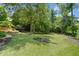 Extensive backyard featuring immaculate landscaping and mature trees, providing privacy and shade at 3770 Riverly Trce, Marietta, GA 30067