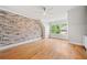 Bedroom boasting wood floors and an exposed brick accent wall at 3770 Riverly Trce, Marietta, GA 30067