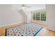 Bedroom with hardwood floors, ceiling fan, and large windows offering ample natural light and a blue area rug at 3770 Riverly Trce, Marietta, GA 30067