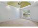 Cozy bedroom with a ceiling fan, neutral carpet, and a large window offering backyard views at 3770 Riverly Trce, Marietta, GA 30067