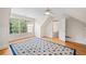 Bedroom with hardwood floors, ceiling fan, and large windows offering ample natural light and a blue area rug at 3770 Riverly Trce, Marietta, GA 30067