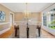 Formal dining room featuring a chandelier, large windows, and neutral decor at 3770 Riverly Trce, Marietta, GA 30067