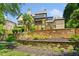 Elegant home exterior with stone retaining wall, covered porch and balcony, plus professionally landscaped garden at 3770 Riverly Trce, Marietta, GA 30067