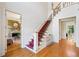 Open foyer with staircase, hardwood floors, and views of a fireplace and living room at 3770 Riverly Trce, Marietta, GA 30067