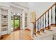 Bright foyer with hardwood floors, staircase, and decorative door leading to the front yard at 3770 Riverly Trce, Marietta, GA 30067