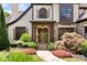 Elegant home featuring a covered front entrance with stone accents, complemented by lush landscaping and a stone walkway at 3770 Riverly Trce, Marietta, GA 30067