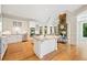 Open kitchen with a large island, breakfast bar, and adjoining living area with fireplace at 3770 Riverly Trce, Marietta, GA 30067