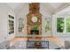 Spacious living room featuring a stone fireplace, hardwood floors, and large windows offering ample natural light at 3770 Riverly Trce, Marietta, GA 30067