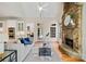Open-concept living room with stone fireplace, hardwood floors, and modern kitchen at 3770 Riverly Trce, Marietta, GA 30067