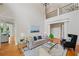 Open-concept living room with an airy feel, hardwood floors, and access to other living spaces at 3770 Riverly Trce, Marietta, GA 30067