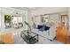 Bright open-concept living space with hardwood floors, seamlessly connecting the living room, sunroom, and kitchen at 3770 Riverly Trce, Marietta, GA 30067