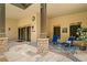 Covered patio featuring stone pillars, outdoor seating, and an elegant entryway with double doors at 3770 Riverly Trce, Marietta, GA 30067