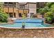 Private pool with a stone waterfall feature, surrounded by lush landscaping and multiple levels for lounging and entertaining at 3770 Riverly Trce, Marietta, GA 30067