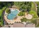 Aerial view of the stunning pool area with a spa, stone patio, and lush tropical landscaping creating a private oasis at 3770 Riverly Trce, Marietta, GA 30067