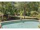 A refreshing in-ground pool is surrounded by a well-manicured lawn and mature trees at 3770 Riverly Trce, Marietta, GA 30067