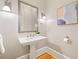 Elegant powder room with pedestal sink and decorative mirror at 3770 Riverly Trce, Marietta, GA 30067