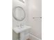 Clean powder room featuring pedestal sink, stylish mirror, and fresh paint at 3770 Riverly Trce, Marietta, GA 30067