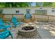Inviting backyard features a paver patio, fire pit, Adirondack chairs, a ramp and a deck on a white home at 1000 Delta Dr, Canton, GA 30114