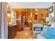 Classic living room with a vintage cabinet, wood paneling and a view towards the kitchen at 1000 Delta Dr, Canton, GA 30114