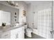 Bright bathroom with white vanity, modern fixtures, and tiled shower with curtain at 22 Airline Ne St # 201, Atlanta, GA 30312