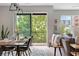 Dining area with modern table, chairs, and sliding glass doors leading to a balcony with greenery at 22 Airline Ne St # 201, Atlanta, GA 30312