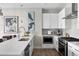 Updated kitchen with white cabinets, stainless steel appliances, and modern fixtures at 22 Airline Ne St # 201, Atlanta, GA 30312