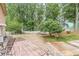A backyard with an empty brick outdoor area and several trees at 568 Musical Ct, Lawrenceville, GA 30044