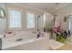 Bathroom features a large tub and a glass-enclosed shower at 568 Musical Ct, Lawrenceville, GA 30044