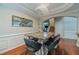 Stylish dining area featuring a modern table and chairs, elegant lighting, and hardwood floors at 568 Musical Ct, Lawrenceville, GA 30044
