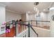 Upstairs landing with railing, wood floors, and view of multiple rooms including a bathroom at 568 Musical Ct, Lawrenceville, GA 30044