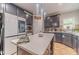 Modern kitchen featuring stainless steel appliances, an island and dark cabinets at 568 Musical Ct, Lawrenceville, GA 30044