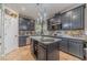 Well-appointed kitchen with stainless steel appliances, granite countertops, and dark wood cabinets at 568 Musical Ct, Lawrenceville, GA 30044
