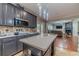 Kitchen with stainless steel appliances and an island, seamlessly connecting to the living room at 568 Musical Ct, Lawrenceville, GA 30044