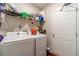 Functional laundry room with washer, dryer, overhead shelving, and storage space for household essentials at 568 Musical Ct, Lawrenceville, GA 30044