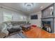 Comfortable living room with plush seating, hardwood floors, and a fireplace for cozy evenings at 568 Musical Ct, Lawrenceville, GA 30044