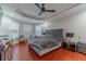 Spacious main bedroom with tray ceiling, dark wood floors and large windows for ample natural light at 568 Musical Ct, Lawrenceville, GA 30044