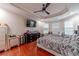 Spacious main bedroom with tray ceiling, dark wood floors, sitting area, ceiling fan and windows at 568 Musical Ct, Lawrenceville, GA 30044