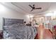 Spacious main bedroom with arched entry, ensuite, dark wood floors and ceiling fan at 568 Musical Ct, Lawrenceville, GA 30044