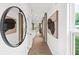 Bright hallway with hardwood floors, modern artwork, and natural light from nearby windows at 5760 Tillman Way, Powder Springs, GA 30127