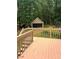 Backyard features a spacious deck leading to a large two-car detached garage and wooded area at 2901 Briscoe Rd, Loganville, GA 30052