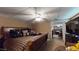 Cozy bedroom featuring a queen-sized bed with decorative pillows, a ceiling fan, and an open doorway at 2901 Briscoe Rd, Loganville, GA 30052