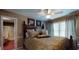 Cozy bedroom featuring a queen-sized bed, ceiling fan and natural light from the large window at 2901 Briscoe Rd, Loganville, GA 30052