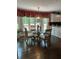Bright dining area featuring dark wood floors, and a modern chandelier at 2901 Briscoe Rd, Loganville, GA 30052