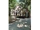 Charming two-story home with manicured landscaping, arched windows, black shutters, and a curved walkway at 2901 Briscoe Rd, Loganville, GA 30052