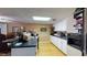 Open concept kitchen with black countertops, white cabinets, stainless steel appliances, and hardwood floors at 2901 Briscoe Rd, Loganville, GA 30052