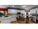 Bright kitchen with white cabinets, stainless steel appliances, and a kitchen island with seating at 2901 Briscoe Rd, Loganville, GA 30052